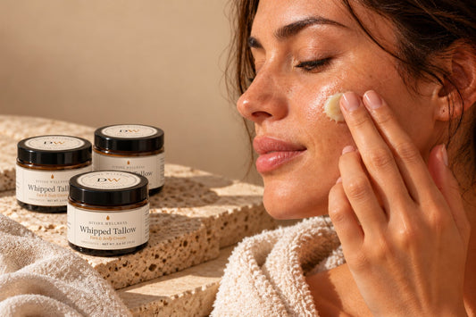 Woman smoothing tallow cream onto her cheek