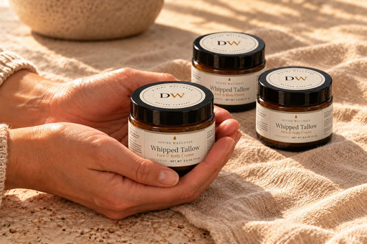 Hands cradling a jar of tallow cream