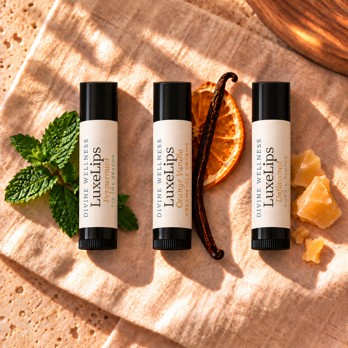 Three LuxeLips lip balms with peppermint, vanilla and orange