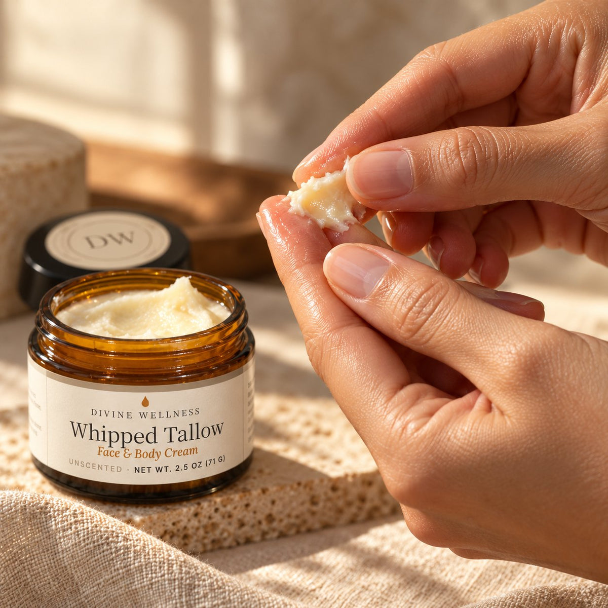 Fingertip scooping whipped tallow cream from the jar